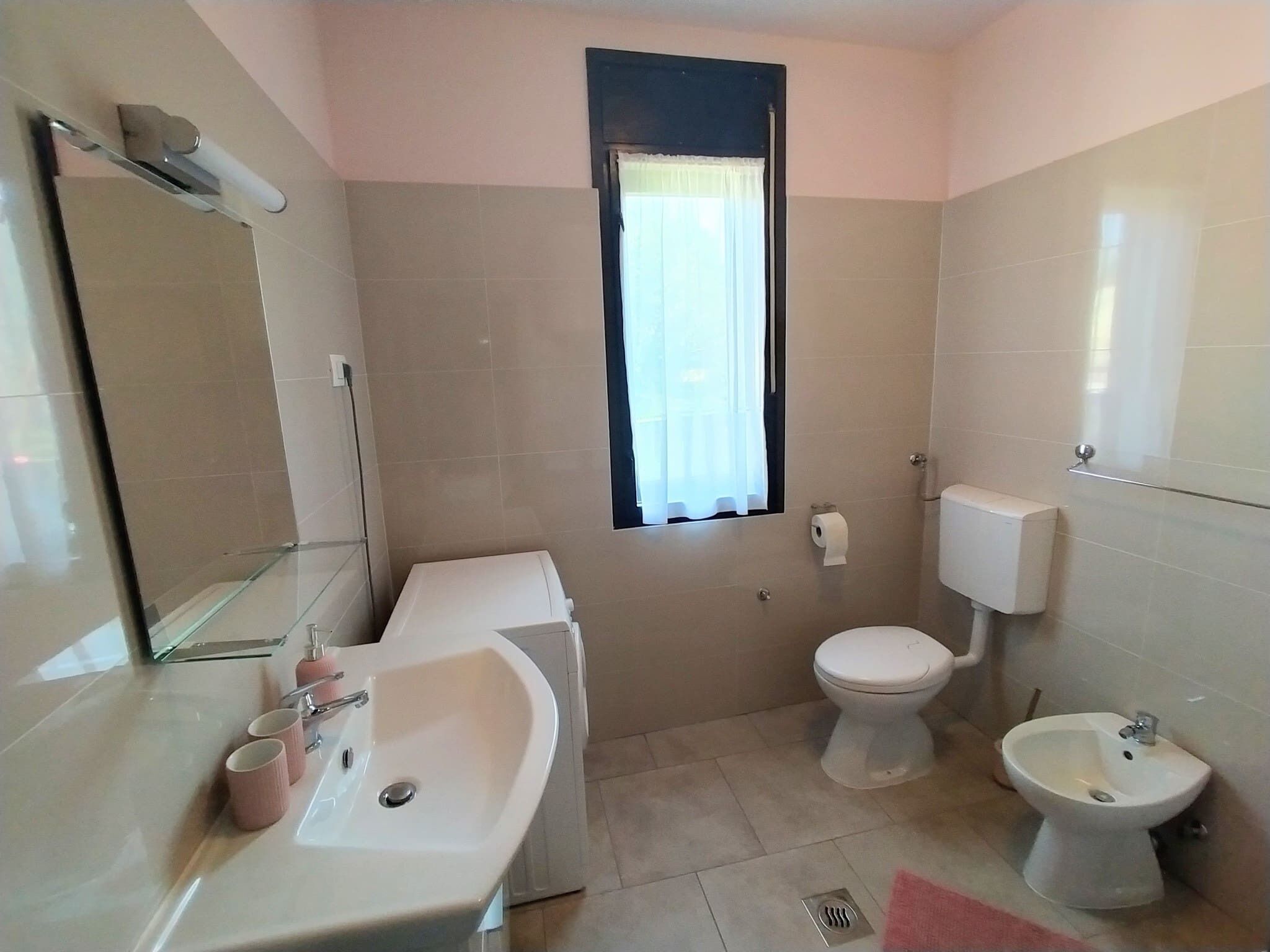 Bathtub, hair dryer, towels, toilet paper