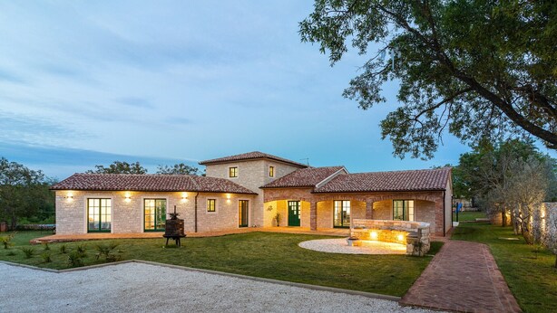 A two-story house with a brick exterior, a well-maintained lawn, and a gravel driveway. - Villa Boris with Private Pool (Vodnjan)