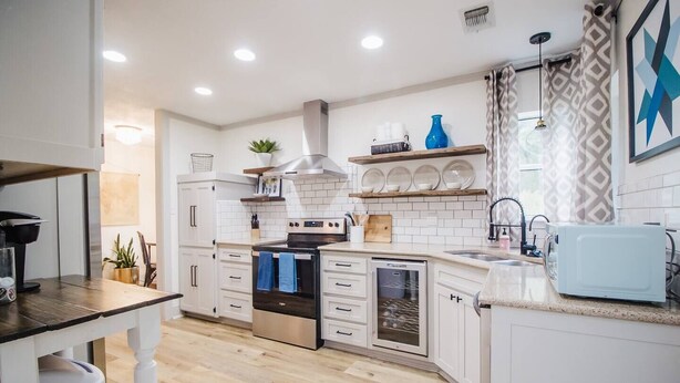 A modern kitchen with white cabinetry, a stainless steel range, and a dishwasher. - Stunning Lake House 4Bdm w/ Sandy Beach Access (Pottsboro)