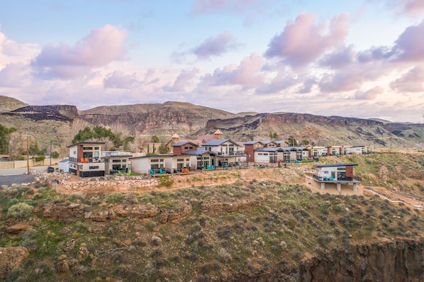 A modern residential area with multiple houses featuring flat roofs and a mix of architectural styles.