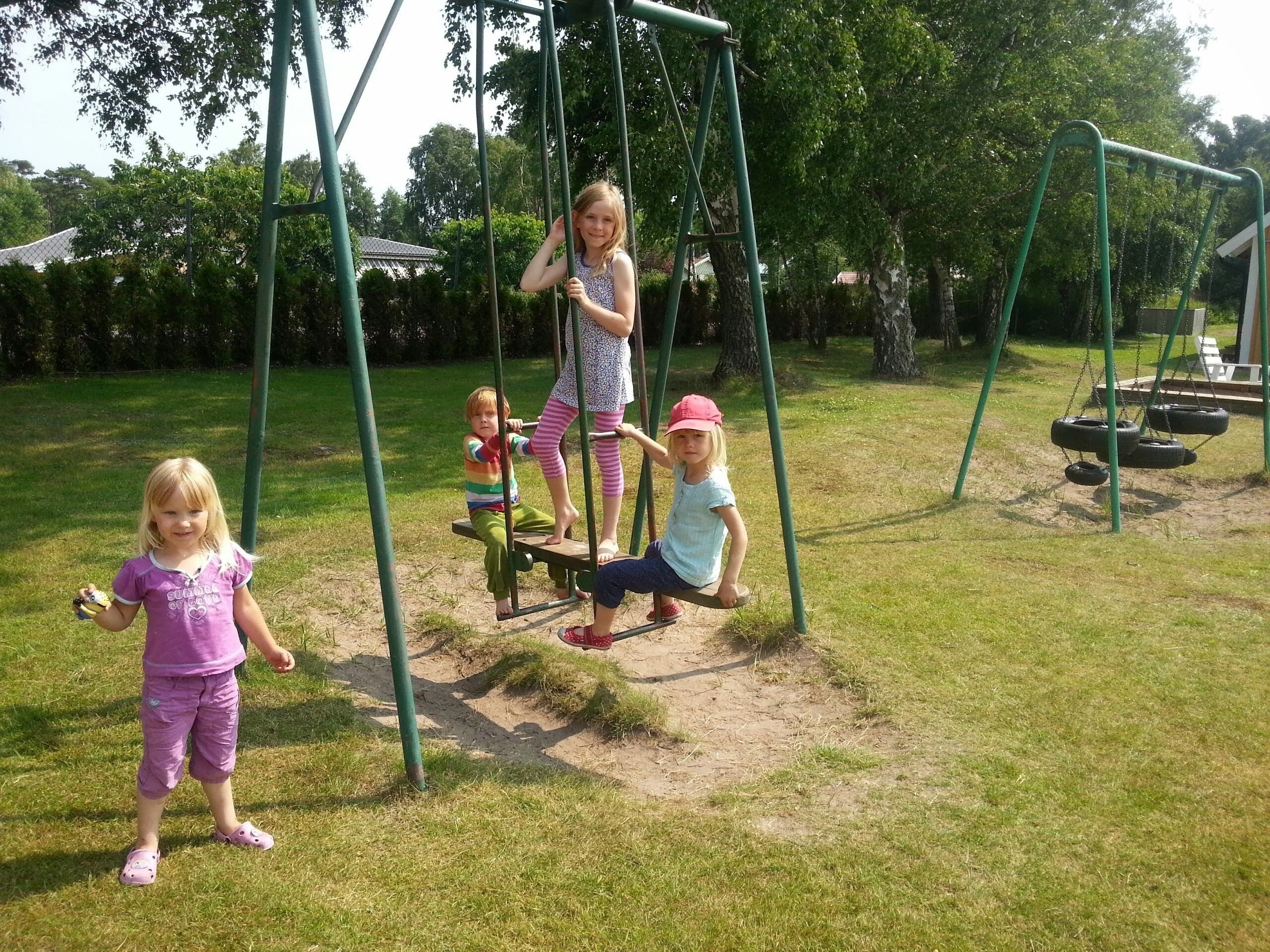 A playground with swings and a slide.