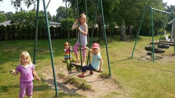 A playground with swings and a slide.