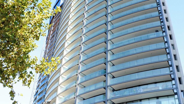 A tall, modern building with a curved facade and numerous balconies. - Apartment - Manquehue - Parque Arauco (santiago)