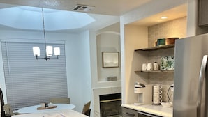 A modern kitchen with a central island, built-in oven, and stainless steel appliances.