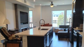 A modern kitchen with a central island, built-in appliances, and a large window providing natural light. - Discount for a 30 day stay! Luxury 4 all queen beds. Walk to the harbor + views (San Pedro)