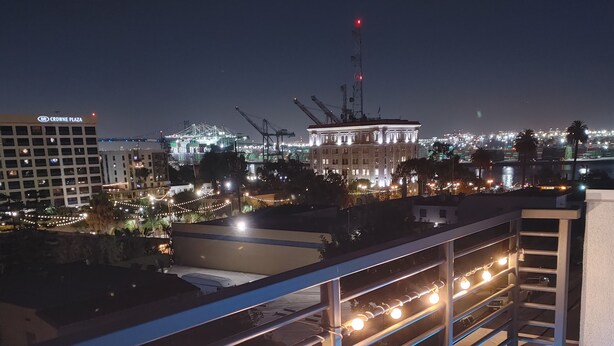 A rooftop terrace with a railing, string lights, and a view of the cityscape at night. - Discount for a 30 day stay! Luxury 4 all queen beds. Walk to the harbor + views (San Pedro)