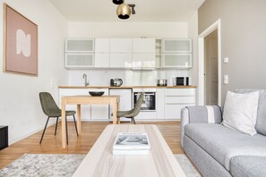 Cozy living space with a kitchenette, dining table, and comfortable seating area.