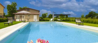Typical Tuscan house with private and fenced swimming pool. View on the village of Castiglion Fioren