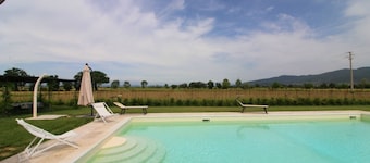 Typical Tuscan house with private and fenced swimming pool. View on the village of Castiglion Fioren