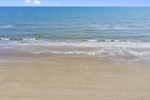 A beach with a sandy shore and gentle waves. - Beach Access, Lux, 6-Person Hot Tub, Decks, Pets, Screened Patio & Games (Crystal Beach)
