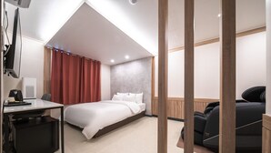 A modern hotel room with a bed, desk, and seating area. - CentroStay (Incheon)