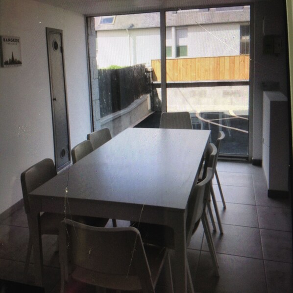 A conference room with a long table, chairs, and a door.