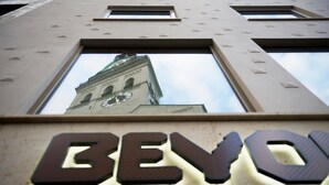 A building with a clock tower and the word 'BEVO' illuminated on its facade. - BEYOND by Geisel (Munich)