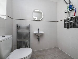 A small, modern bathroom with a toilet, sink, and towel rack. - Spacious 3bed Property With Parking Large Garden (South Ockendon)
