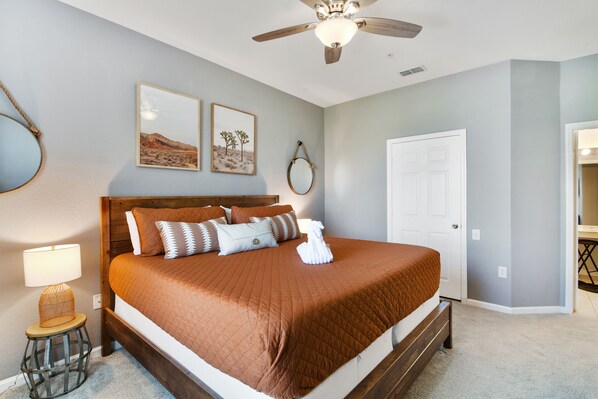 A bedroom with a large bed, a ceiling fan, and two framed pictures on the wall. - 3BR Disney Condo, 2 King Beds, Star Wars Room, Water Park, 3 miles to Disney (Kissimmee)