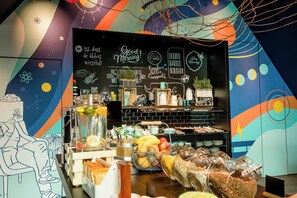 A breakfast buffet with various food items and a chalkboard with menu options.