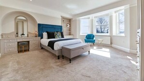 A bedroom with a large bed, a desk, a chair, and a window. - Host & Stay | The Old Rectory (Witton Gilbert)