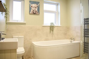 Bathtub, hair dryer, towels, soap