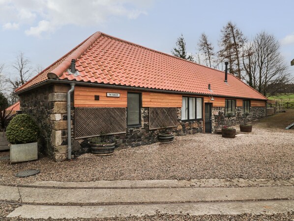 A building with a red-tiled roof, stone walls, and a wooden sign that reads "THE BAKERY". - The Bakery (Belford)