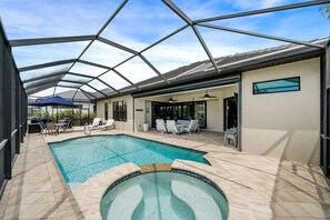 Outdoor pool, a heated pool - Come visit Boaters Delight in SW Cape-Large Pool/Spa home on canal w/ boatlift! (Cape Coral)