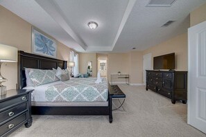 A bedroom with a bed, dresser, nightstand, lamp, and artwork. - 576 - Stunning Modern Resort Home With Private Pool And Spa (Davenport)