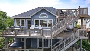 A two-story house with a deck and a staircase. - Raise The Jolly Roger: Pool, Hot Tub, 9-Min Walk Beach (Corolla)