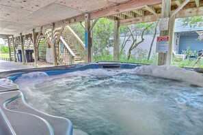 A hot tub area with wooden structures and a sign indicating spa rules.