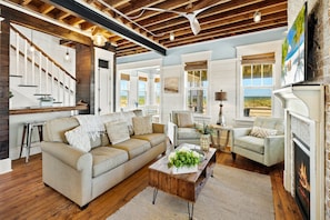 A spacious living room with a fireplace, a sofa set, and a coffee table.