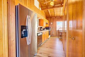 Enjoy cooking in this well-equipped kitchen with a refrigerator, water dispenser, and microwave.