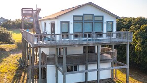 A two-story house with a balcony and a wooden deck. - Denna's Favorite Place: Golf Views, Walk to Beach (Kitty Hawk)