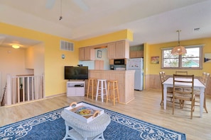 A compact apartment with a kitchen, dining area, and living space.
