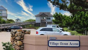 A private entrance with a stone wall and a sign reading "Village Ocean Access." - 6140 Spindrift * On the Golf Course (Nags Head)