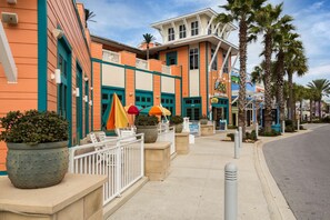 Experience the retro charm of this vibrant hotel, featuring a flat roof and balcony with outdoor seating areas.