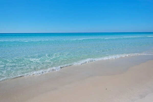 Enjoy serene beach views with calm waters and a sandy shore.