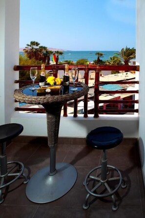 Enjoy a dining experience with a view of the sea from this enclosed outdoor seating area.
