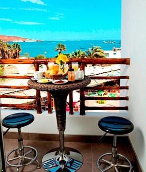 Enjoy a refreshing drink on the balcony with a stunning sea view.