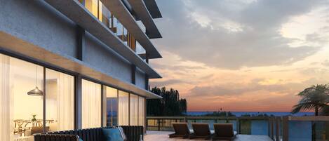 A modern outdoor living area with a sofa, chairs, and a coffee table.