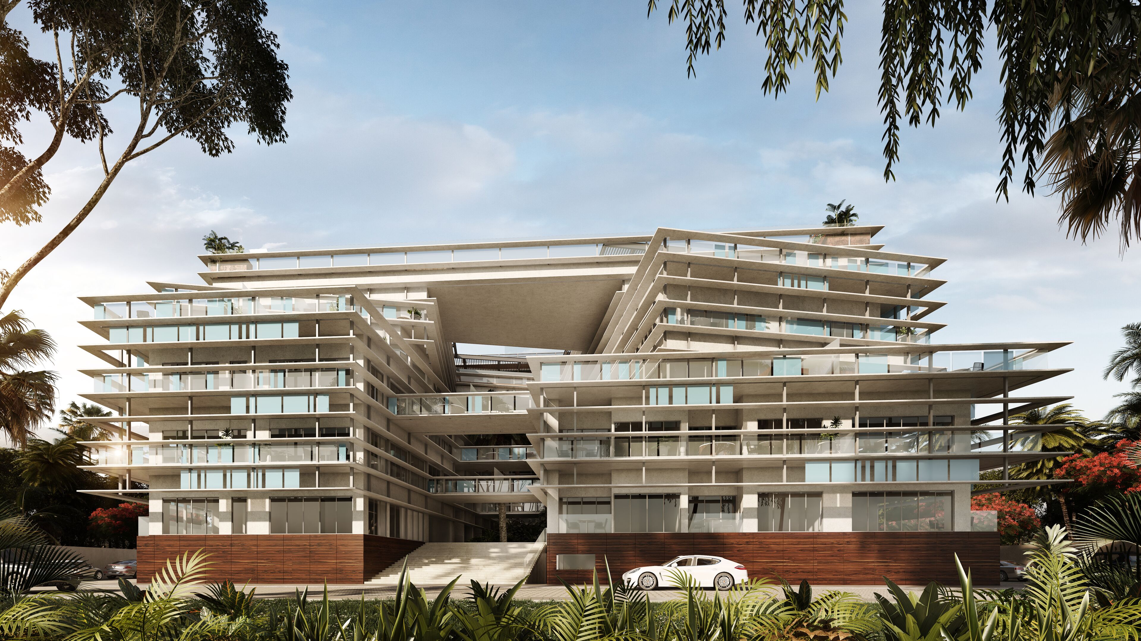 Un immeuble moderne à plusieurs étages, doté d’une architecture originale aux lignes angulaires, de balcons et de grandes fenêtres.