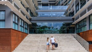 A modern building with a staircase leading to an upper level. - Singular Dream Beach Residences (Playa del Carmen)