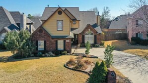 A residential house with a brick facade, a yellow front section, and a garage. - The Erie Home: Warm and Spacious in South Tulsa (Tulsa)