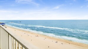 A beach with a pier extending into the ocean, a sandy shore, and a clear sky. - Beachfront 2BR +Bonus Room @ Lighthouse • Sleeps 8 • Pools & Walk to The Hangout (Gulf Shores)