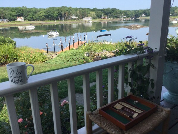 A balcony with a view of a lake, boats, and a mug labeled "Mrs. Always Right". - Waterfront Designer Home with Private Dock on Paddy Cove in Cape Porpoise (Kennebunkport)