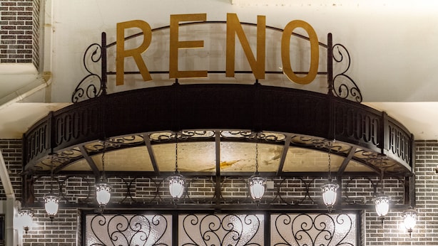 A theater entrance with a sign reading "RENO" and decorative ironwork. - Reno Apartments Abuja (Abuja)