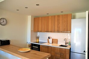 Enjoy cooking in this kitchen with dishwasher, stainless steel refrigerator, and sink with faucet.