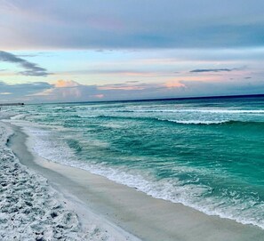 A beach with waves, a pier, and a cloudy sky. - Spacious 2-Level End Unit Just Steps From the Beach With Private Patio & Balcony (Panama City Beach)