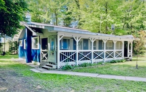 Guests can enjoy a peaceful stay in this cozy single-story building with a porch.