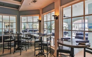 A restaurant with large windows, tables, and chairs. - New Listing "Sol Intention" 3 Bedroom Villa Capriani, fully renovated (North Topsail Beach)