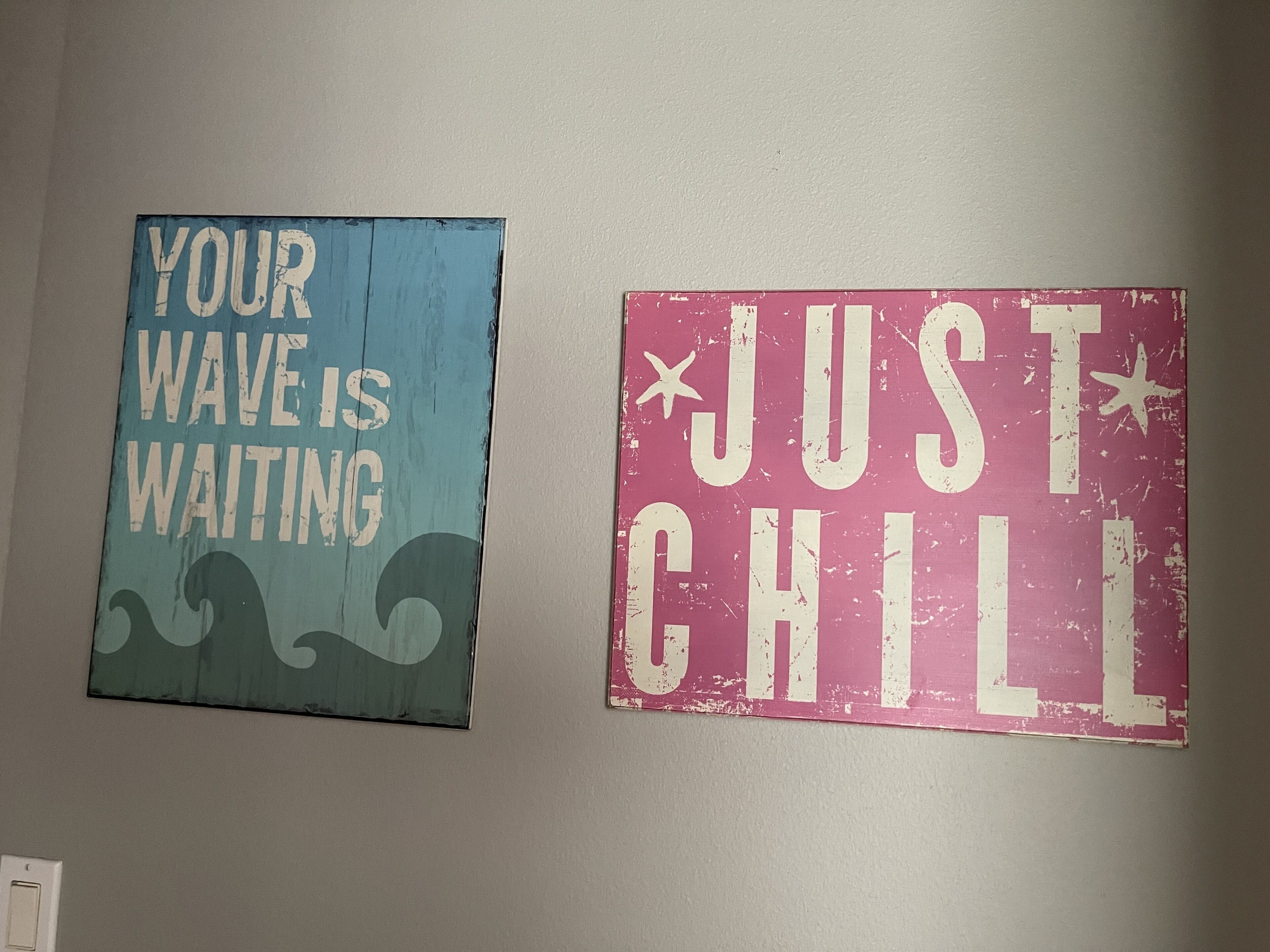 Two wall signs with motivational phrases.
