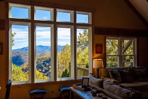A cozy room with a large window offering a mountain view. - THE HEAD REST at Deals Gap, Tail of the Dragon Mountain Retreat! (Robbinsville)