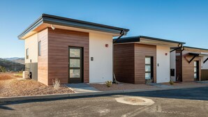 A modern building with two units, each with a large window and a door, numbered 1 and 2. - Amazing View #1 Pet Friendly (La Verkin)